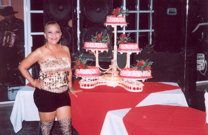 La festejada y su esposo en plena celebración en compañía del mariachi.