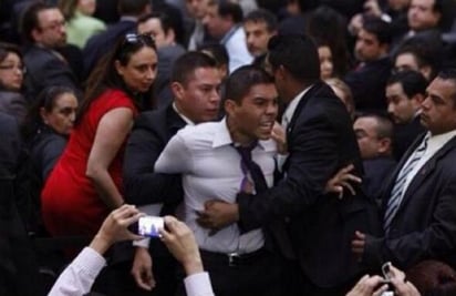 El joven fue retirado a empujones del recinto por elementos del Estado Mayor Presidencial. (ESPECIAL)