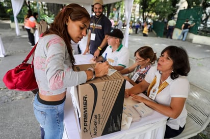 Elección. Una mujer participó en la votación de las primarias de la alianza MUD. (EFE)