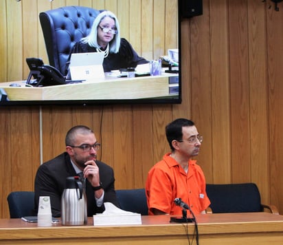 El exmédico Larry Nassar, derecha, escucha junto a su abogado Matthew Newberg mientras la jueza Janice Cunningham dicta una nueva sentencia a Nassar en la Corte de Circuito del condado Eaton en Charlotte. (AP)