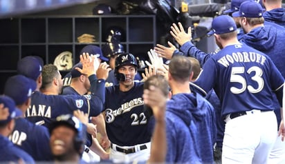 Christian Yelich celebra en el dugout tras batear un jonrón de dos carreras.