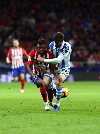 El defensa de la Real Sociedad Raúl Navas (d) lucha con Thomas Lemar.