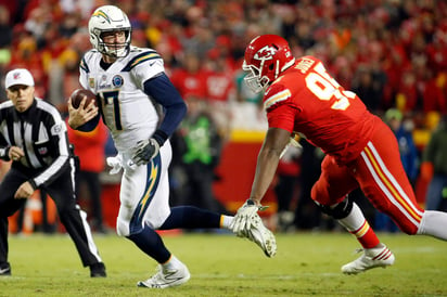 Philip Rivers (17) escapa de la defensiva de Kansas City en un partido de la temporada 2018 de la NFL.