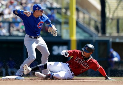 Javier Báez, de los Cachorros, lanza a la inicial tras poner out a Ketel Marte, de los Diamondbacks, en un juego de pretemporada.