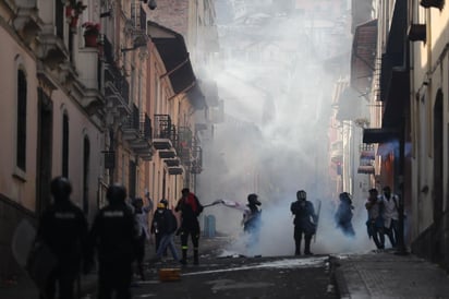 El forcejeo se produjo mientras la televisión informaba de la llegada del presidente a Quito. (EFE)