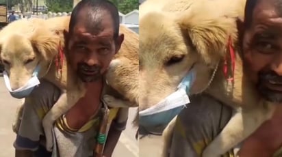 El hombre ha conmovido en redes al mostrarse cargando al can y 'protegiéndolo' contra el COVID-19 (CAPTURA) 