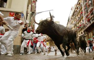 Miles de temerarios se lanzaron a las calles de esta ciudad española para correr delante de una manada de toros, celebrando el primer encierro de los sanfermines del 2003.