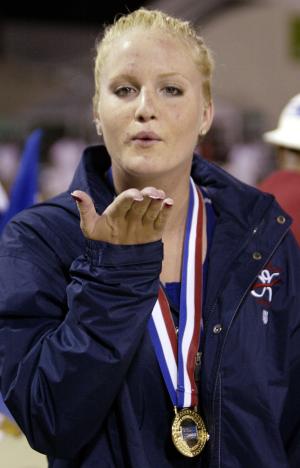 La estadounidense Diana Macmanus manda un beso arriba del podio cuando recibió la medalla de oro por los 100 metros espalda en natación.