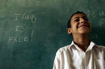 Esta foto de Cheryl Diaz Meyer, muestra a un niño en su escuela, junto a la pizarra, donde se puede leer 'Iraq is free!' (Irak es libre!), en Bagdad.