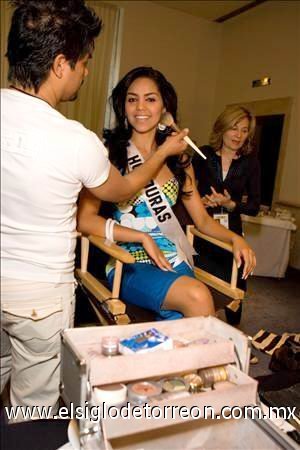 Un hombre maquilla a la representante de Honduras, Wendy Salgado.