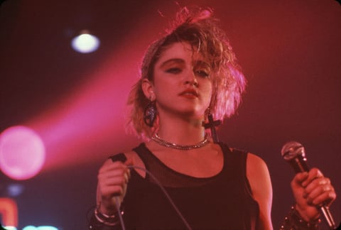 Entró al mundo del cine en 1985, con una breve aparición como cantante de un club en la película Vision quest.