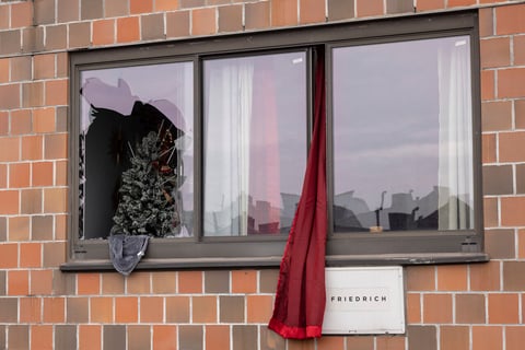 A curtain hangs outside a window at an apartment building in the Bronx on Sunday, Jan. 9, 2022, in New York, where a fatal fire occurred, in what the city's fire commissioner called one of the worst blazes in recent memory. (AP Photo/Yuki Iwamura)