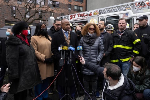 New York City Mayor Eric Adams, middle, speaks during a news conference outside an apartment building where a deadly fire occurred in the Bronx on Sunday, Jan. 9, 2022, in New York. (AP Photo/Yuki Iwamura)