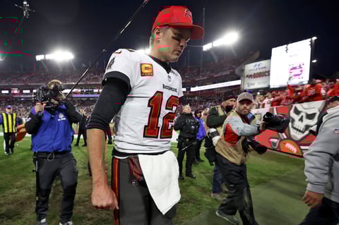 Tampa Bay Buccaneers quarterback Tom Brady (12) reacts as he leaves the field after the team lost to the Los Angeles Rams during an NFL divisional round playoff football game Sunday, Jan. 23, 2022, in Tampa, Fla. (AP Photo/Mark LoMoglio)