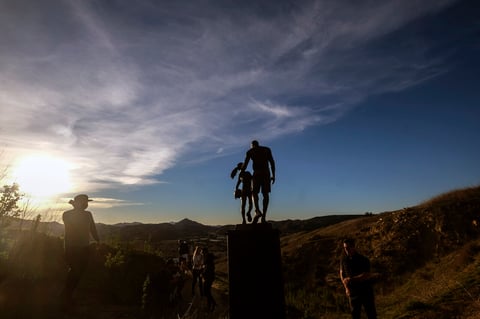 A bronze sculpture honoring former Los Angeles Lakers NBA basketball player Kobe Bryant, his daughter Gianna Bryant, and the names of those who died, is displayed at the site of a 2020 helicopter crash in Calabasas, Calif, on Wednesday, Jan. 26, 2022. (AP Photo/Ringo H.W. Chiu)