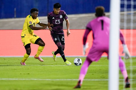 Jamaica's Javain Brown, left, challenges Mexico's Jesus Gallardo dribbling during a qualifying soccer match for the FIFA World Cup Qatar 2022 in Kingston, Jamaica, Thursday, Jan. 27, 2022. (AP Photo/Ramon Espinosa)