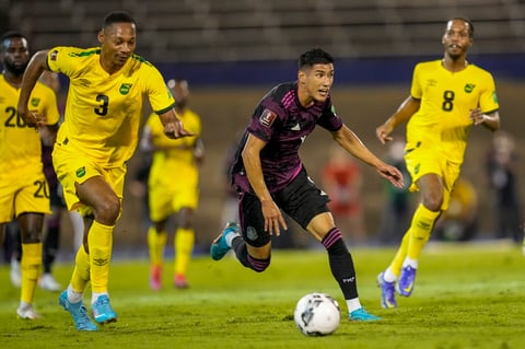Mexico's Carlos Antuna dribbles past Jamaica's Ethan Pinnock (3) during a qualifying soccer match for the FIFA World Cup Qatar 2022 in Kingston, Jamaica, Thursday, Jan. 27, 2022. (AP Photo/Ramon Espinosa)