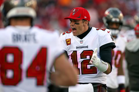 Tampa Bay Buccaneers quarterback Tom Brady (12) tries to fire up the team during the second half of an NFL divisional round playoff football game against the Los Angeles Rams Sunday, Jan. 23, 2022, in Tampa, Fla. (AP Photo/Mark LoMoglio)