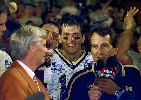 1999 FedEx Orange Bowl-University of Michigan vs Alabama at Pro Player Stadium in Miami, Jan. 1, 1999. Michigan quarterback Tom Brady, center, with coach Lloyd Carr, right. (AP Photo/The Detroit News, Daniel Mears)