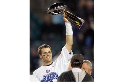 FILE - In this Feb. 6, 2005, file photo, New England Patriots quarterback Tom Brady raises the Vince Lombardi Trophy over coach Bill Belichick and team owner Robert Kraft, right, after they beat the Philadelphia Eagles, 24-21, in Super Bowl 39 in Jacksonville, Fla. Tom Brady has retired after winning seven Super Bowls and setting numerous passing records in an unprecedented 22-year-career. He made the announcement, Tuesday, Feb. 1, 2022, in a long post on Instagram.  (AP Photo/Julie Jacobson, File)