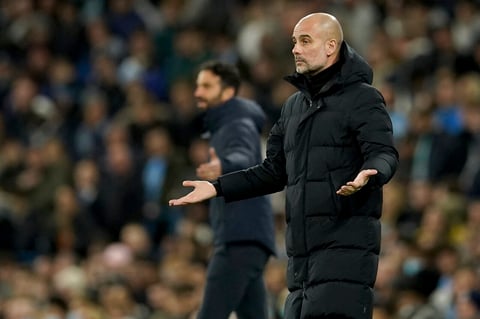 Manchester City's head coach Pep Guardiola reacts during the Champions League round of 16 second leg soccer match between Manchester City and Sporting Lisbon at the City of Manchester Stadium in Manchester, England, Wednesday, March 9, 2022. (AP Photo/Dave Thompson)