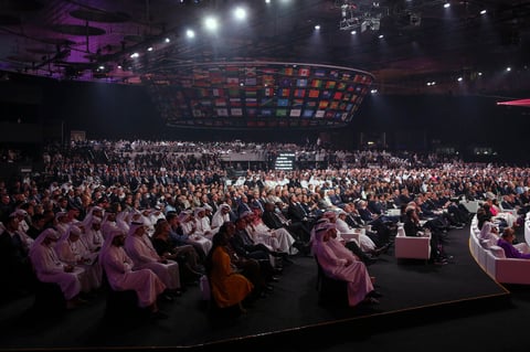 People attend the 2022 soccer World Cup draw at the Doha Exhibition and Convention Center in Doha, Qatar, Friday, April 1, 2022. (AP Photo/Hussein Sayed)