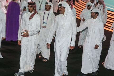 Emir of Qatar Sheikh Tamim bin Hamad Al Thani, center, smiles during the 2022 soccer World Cup draw at the Doha Exhibition and Convention Center in Doha, Qatar, Friday, April 1, 2022. (AP Photo/Hussein Sayed)