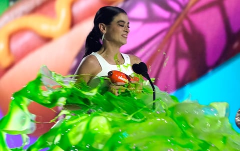 Dixie D'Amelio gets slimed as she accepts the award for favorite social music star at the Kids Choice Awards on Saturday, April 9, 2022, at the Barker Hangar in Santa Monica, Calif. (AP Photo/Chris Pizzello)