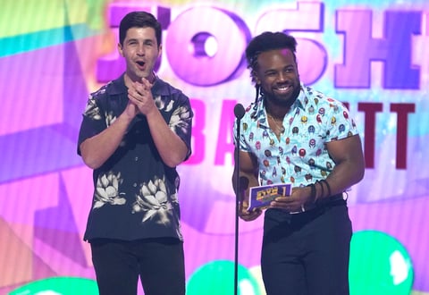 Josh Peck, left, and Xavier Woods present the award for favorite male TV star at the Kids Choice Awards on Saturday, April 9, 2022, at the Barker Hangar in Santa Monica, Calif. (AP Photo/Chris Pizzello)