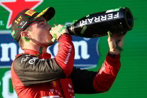 Ferrari driver Charles Leclerc of Monaco drinks champagne on the podium after winning the Australian Formula One Grand Prix in Melbourne, Australia, Sunday, April 10, 2022. (AP Photo/Asanka Brendon Ratnayake)