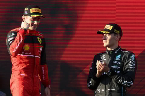Ferrari driver Charles Leclerc of Monaco celebrates after winning the Australian Formula One Grand Prix as third placed Mercedes driver George Russell, right, of Britain watches in Melbourne, Australia, Sunday, April 10, 2022. (AP Photo/Asanka Brendon Ratnayake)