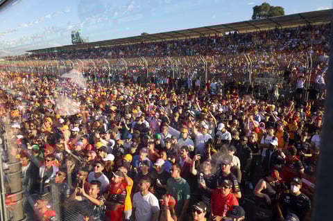 Spectators watch the trophy presentation at the Australian Formula One Grand Prix in Melbourne, Australia, Sunday, April 10, 2022. (AP Photo/Asanka Brendon Ratnayake)