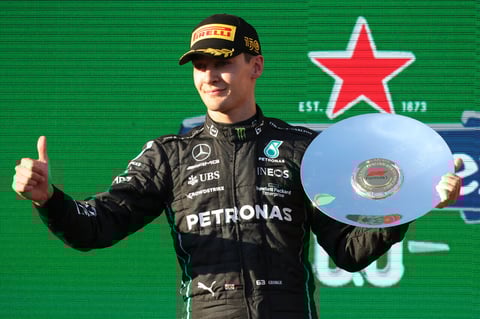Mercedes driver George Russell of Britain gestures as he holds his trophy after his third place finish at the Australian Formula One Grand Prix in Melbourne, Australia, Sunday, April 10, 2022. (AP Photo/Asanka Brendon Ratnayake)