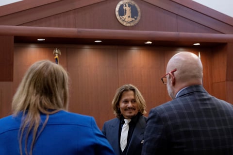 Johnny Depp stands inside a courtroom at the Fairfax County Circuit Court, Tuesday, April 12, 2022, in Fairfax, Va. A jury in Virginia is scheduled to hear opening statements Tuesday in a defamation lawsuit filed by Johnny Depp against his ex-wife, Amber Heard. (Brendan Smialowski/Pool Photo via AP)