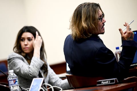 US actor Johnny Depp (R) gestures during the $50 million Depp vs Heard defamation trial at the Fairfax County Circuit Court in Fairfax, Virginia, on April 12, 2022. (Photo by Brendan SMIALOWSKI / POOL / AFP)