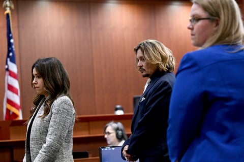 US actor Johnny Depp (C) looks on during the $50 million Depp vs Heard defamation trial at the Fairfax County Circuit Court in Fairfax, Virginia, on April 12, 2022. (Photo by Brendan SMIALOWSKI / POOL / AFP)