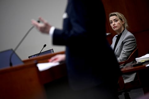 Actress Amber Heard listens inside the courtroom at the Fairfax County Circuit Court, April 12, 2022, in Fairfax, Va. A jury in Virginia is scheduled to hear opening statements in a defamation lawsuit filed by Johnny Depp against his ex-wife, Amber Heard. (Brendan Smialowski, Pool via AP)