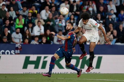 VALENCIA, 21/04/2022.- El delantero del Levante José Luis Morales (i) pelea un balón con Jules Koundé, del Sevilla, durante el partido de Liga en Primera División que disputan hoy jueves en el estadio Ciudad de Valencia. EFE/Manuel Bruque