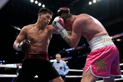Dmitry Bivol, left, of Kyrgyzstan, throws a punch against Canelo Alvarez, of Mexico, during a light heavyweight title fight, Saturday, May 7, 2022, in Las Vegas. (AP Photo/John Locher)
