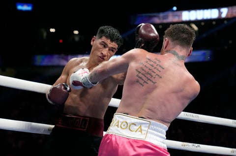 Dmitry Bivol, left, of Kyrgyzstan, throws a punch against Canelo Alvarez, of Mexico, during a light heavyweight title fight, Saturday, May 7, 2022, in Las Vegas. (AP Photo/John Locher)