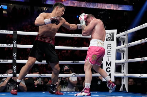 Dmitry Bivol, left, of Kyrgyzstan, throws a punch against Canelo Alvarez, of Mexico, during a light heavyweight title fight, Saturday, May 7, 2022, in Las Vegas. (AP Photo/John Locher)