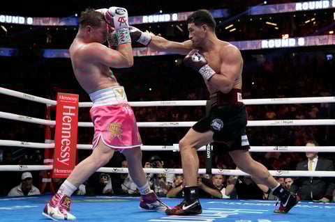 Dmitry Bivol, right, of Kyrgyzstan, throws a punch against Canelo Alvarez, of Mexico, during a light heavyweight title fight, Saturday, May 7, 2022, in Las Vegas. (AP Photo/John Locher)