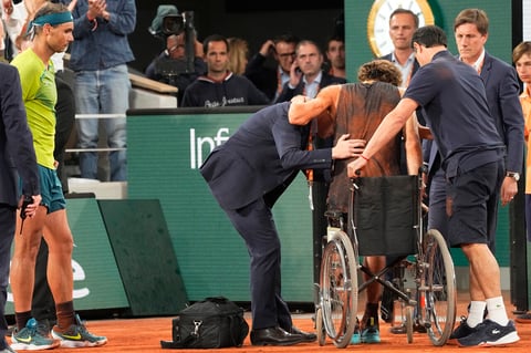Spain's Rafael Nadal, left, watch Germany's Alexander Zverev being helped to sit on a wheelchair during their semifinal match of the French Open tennis tournament at the Roland Garros stadium Friday, June 3, 2022 in Paris. (AP Photo/Michel Euler)