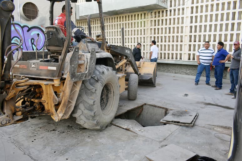 La maquinaria tipo trascabo que ingresó para tratar de remover los locales tuvo un incidente sobre la tapa de una de las cisternas. (JOEL MENDOZA)