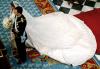 El príncipe Felipe esperó unos minutos solo en el altar hasta que llegó Letizia, ataviada con un traje del diseñador Manuel Pertegaz, que iba ceñido al talle y con cuello corola, de color blanco y realizado en seda natural valenciana con hilos de plata fina.