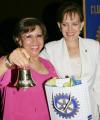 La señora Jose ávila de Ruiz recibe de manos de la esposa del gobernador rotario, Elisa Salazar de Morales, una campaña comio símbolo de la celebración de los 100 años de Rotary.
