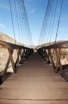 PUENTE DE OJUELA.

Caminar en una superficie de aproximadamente 318 metros de largo que tiene 1.83 de ancho no es sencillo. Sobre todo cuando el puente está suspendido sobre la barranca, entre el Campo Sur y Ojuela, separados por un abismo de casi 100 metros de profundidad.