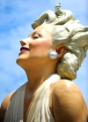 Visitantes posan debajo de una estatua gigante de la actriz Marilyn Monroe.