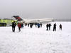 Los pasajeros abandonaron el avión deslizándose por una rampa inflable hacia el pavimento cubierto de nieve.