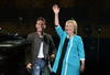 Vestida con pantalón negro y chaqueta turquesa, Clinton saludó brevemente al cantante y a los presentes.